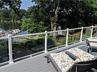 <b>Trex Select Pebble Gray Decking with White Ultralox Aluminum Railing with Full Glass Panel Infills in Severna Park MD</b>